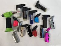 Photo showing the full set of 16 assorted torch lighters with various colors and shapes from top and side angles