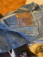 Close-up of men's Lee jeans showing leather Lee brand patch on waistband