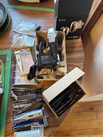 Full overview of lot showing Libiy rotary shaver with box, charger, Panasonic shaver, grooming scissors, nail clippers, toe clipper, and digital thermometer.