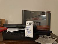 Four men's wallets, Brookstone coin counter, Wahl home haircut system with assigned lot tag