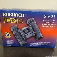 Box of Bushnell PowerView 8x21 binoculars showing product image and specifications