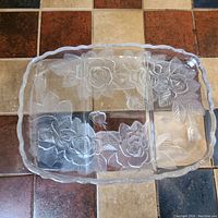 Top-down view of clear crystal appetizer serving tray with three compartments and floral rose etching