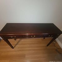 Top view of the cherrywood hallway table showing dark polished surface and drawer layout