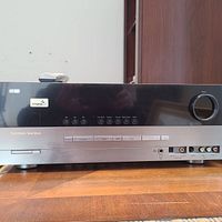 Front view of Harman Kardon AVR 247 audio/video receiver showing input buttons, headphone jack, and volume knob.