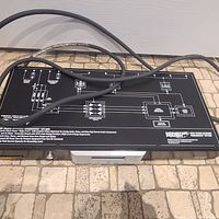 Top view of Monster Power HTS1600 power center showing wiring schematic diagram and thick power cable.