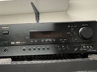 Front view of Onkyo TX-SR600 AV receiver showing controls, inputs, display, and brand markings.
