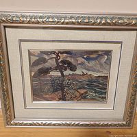 Framed unsigned landscape painting showing ocean scene with trees and cloudy sky.