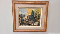 Photo of an unsigned oil painting depicting a forest scene including pine and birch trees, rocks, and a cloudy sky, framed with wooden frame and beige matting with inner gold trim.