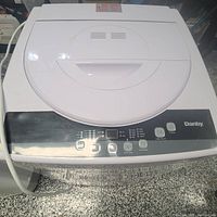 Front view of washing machine with closed lid showing control panel and Danby branding.