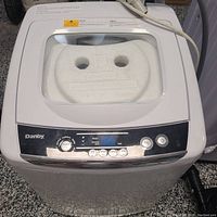 Top view of the portable Danby washer with a closed transparent lid showing control panel and power cord.