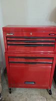 Front view of entire tool chest showing drawers, cabinet, and caster wheels