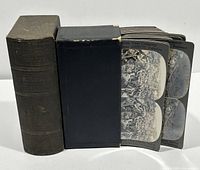 Original black cloth slipcase and stack of stereoview cards displayed together
