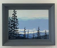 Full view of framed oil painting showing grey wooden frame and mountain landscape scene with pine silhouettes