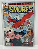 Front cover of Marvel Comics Smurfs #1 comic showing cover art of a Smurf flying a red airplane and a man looking up.