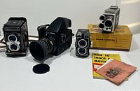 Group shot of all four cameras and accessories