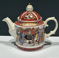 Front and side view of the teapot showing Charles Dickens portrait on lid, Pickwick Papers text, and detailed character scene with carriage.