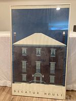 Front view of the Decatur House framed print showing the artwork and the frame with reflection glare.
