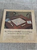 Top view of the original box lid showing vintage Scrabble game artwork and company details