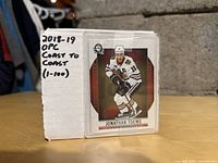 Box labeled '2018-19 OPG Coast to Coast (1-100)' featuring image of Jonathan Toews hockey card on side.