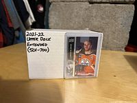 Closed box labeled '2021-22 Upper Deck Extended (501-700)' with a single player's card featured on the box.