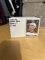 Closed white box labeled '2022-23 Upper Deck Series 1 (1-200)' showing a front hockey player card on outside of box.