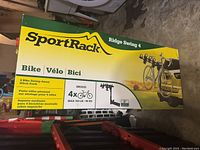 Box of SportRack Ridge Swing 4 Bike Swing-Away Hitch Rack showing brand, model, and bike capacity details.