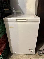 White Danby Diplomat chest freezer with external temperature knob and logo visible