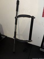 Side view of the adjustable chin up bar showing foam padding condition and metal frame.