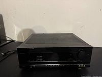 Front view of Harman Kardon AV40 receiver showing control panel and volume knob.