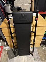 Front view of Moto Master shop creeper showing padded surface and metal frame.