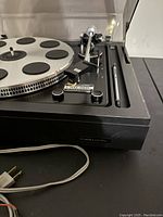 Close-up side view of the player showing the Realistic label and control knobs.