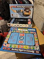 Vintage VCR Hockey Night In Canada board game box open with game board, VHS tape and pieces visible.