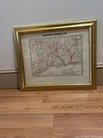 Framed map showing Connecticut Railroads in 1878 with gold textured frame, placed against a wall on the floor.