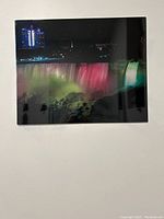Photo of the 16x20 metal print showing Niagara Falls at night with colorful illumination and city lights in the background