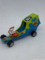Photo of the right side of the 2003 Dr. Seuss Cat in the Hat Hot Wheels car showing cartoon graphics and engine detail.