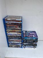 Stack of Blu-Ray movie cases arranged vertically, titles visible include 'War', 'African Cats', 'Step Brothers' and more.