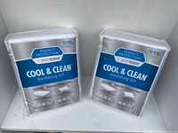 Two brand new Allerease Perfect Protection Cool & Clean bedding kits in plastic packaging, size Twin/Extra Long, sealed and unopened.
