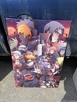 Front angle view of the Mangna Naruto themed canvas wall art showing multiple key characters in a dark red and black color scheme with glowing red moon background.
