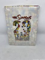 Front view of the DVD set showing cover art and title 'The Simpsons 20 Years The Complete Twentieth Season'.
