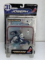 Front view of sealed McFarlane Curtis Joseph hockey figure in packaging showing packaging graphics and figure details.