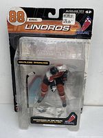 Original packaging showing Eric Lindros figure in Philadelphia Flyers uniform along with a separate hockey stick accessory.