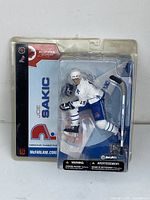 Front view of the McFarlane Joe Sakic hockey figure in original packaging showing figure and branding clearly.