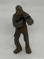 Front view of 4-inch Chewbacca toy showing detailed fur texture, blaster and face.