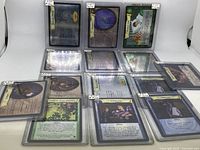 Fourteen Harry Potter collectible cards visibly individually sleeved and laid out with front and back artwork shown for some of them.