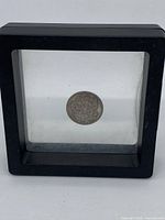 Front view of the 1910 Russia 10 Kopeks silver coin in a black square display frame