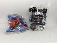 Two new in package toys from Cineplex visible. Mario Kart toy with Mario character and Screen Buddies toy in sealed plastic bags.