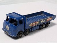 Side view showing blue flatbed truck with Eveready for Life! decals and six black wheels.