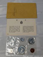 Sealed 1967 Canadian coin set displayed in original plastic seal with envelope and care instruction sheet.