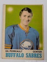 Front view of 1970-71 OPC hockey card showing Gil Perreault in Buffalo Sabres jersey with team name and player position.