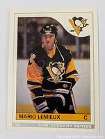 Front side of the 1992 OPC Mario Lemieux hockey card showing player in Pittsburgh Penguins uniform in full color with team logo and card number 18.